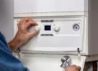 Technician adjusting boiler control panel during 24/7 emergency boiler services Arizona