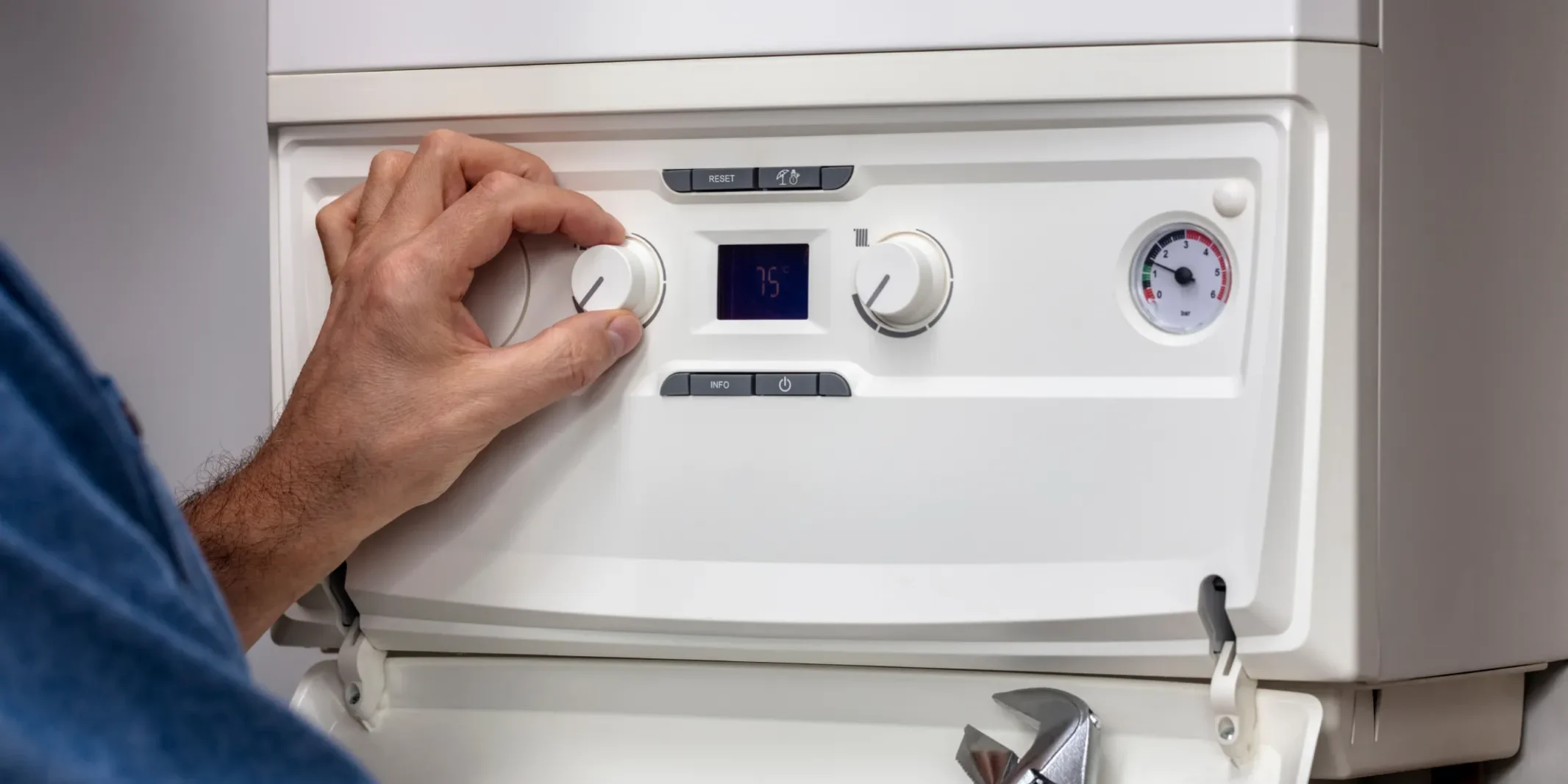 Technician adjusting boiler control panel during 24/7 emergency boiler services Arizona