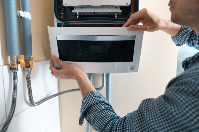 Man Inspecting Home Boiler