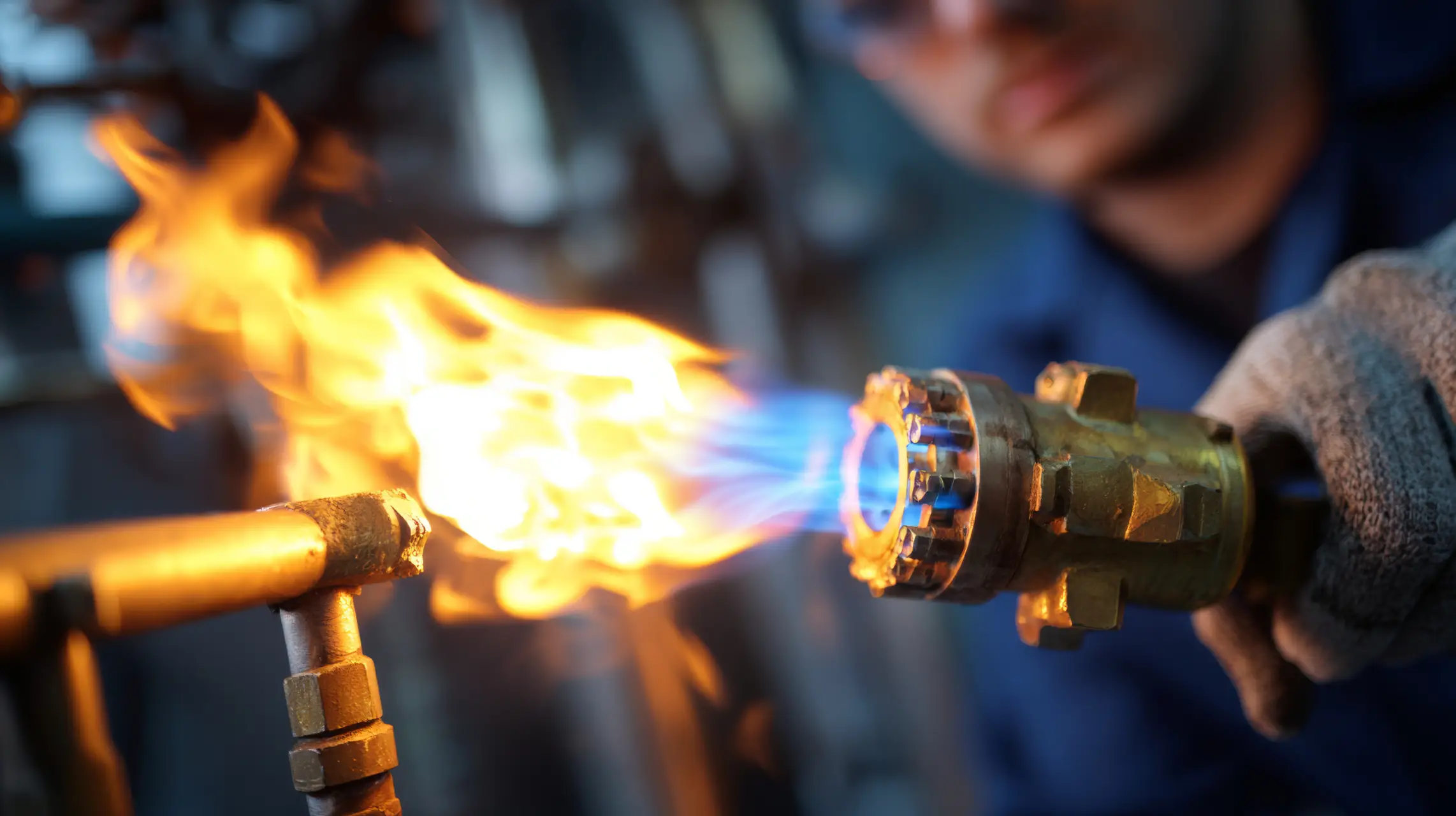 Burner tune-up services — technician adjusting active burner flame