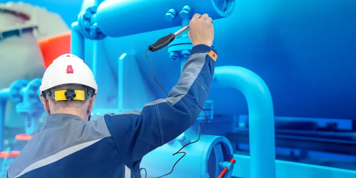 Burner tune-up services — technician inspecting industrial gas fuel line