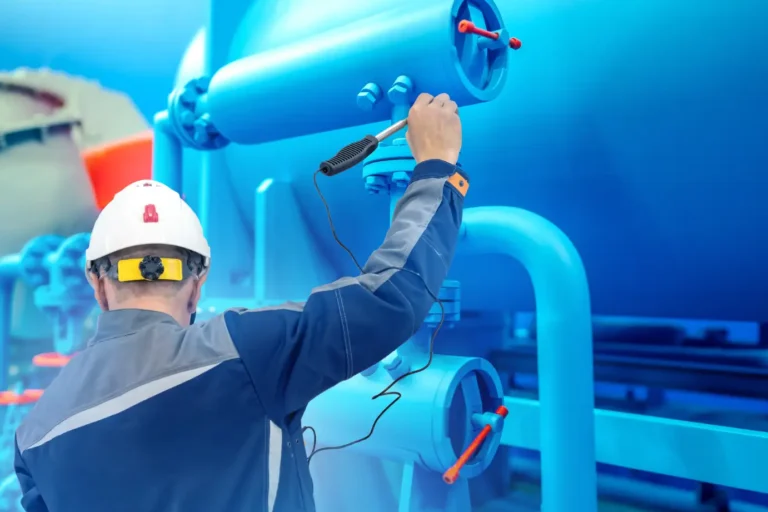 Burner tune-up services — technician inspecting industrial gas fuel line