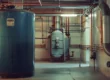 Large commercial water heaters and boilers in a commercial building supported by emergency boiler services
