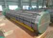 Fully assembled industrial tube bundle with tube sheet and baffles staged in fabrication shop