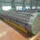 Fully assembled industrial tube bundle with tube sheet and baffles staged in fabrication shop