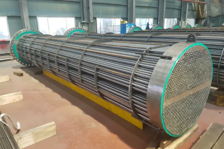 Fully assembled industrial tube bundle with tube sheet and baffles staged in fabrication shop
