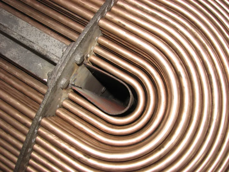 Close-up view of Industrial Tube Bundles in Phoenix, featuring tightly packed copper U-bend tubes and welded support plates used in heat exchanger and boiler applications.